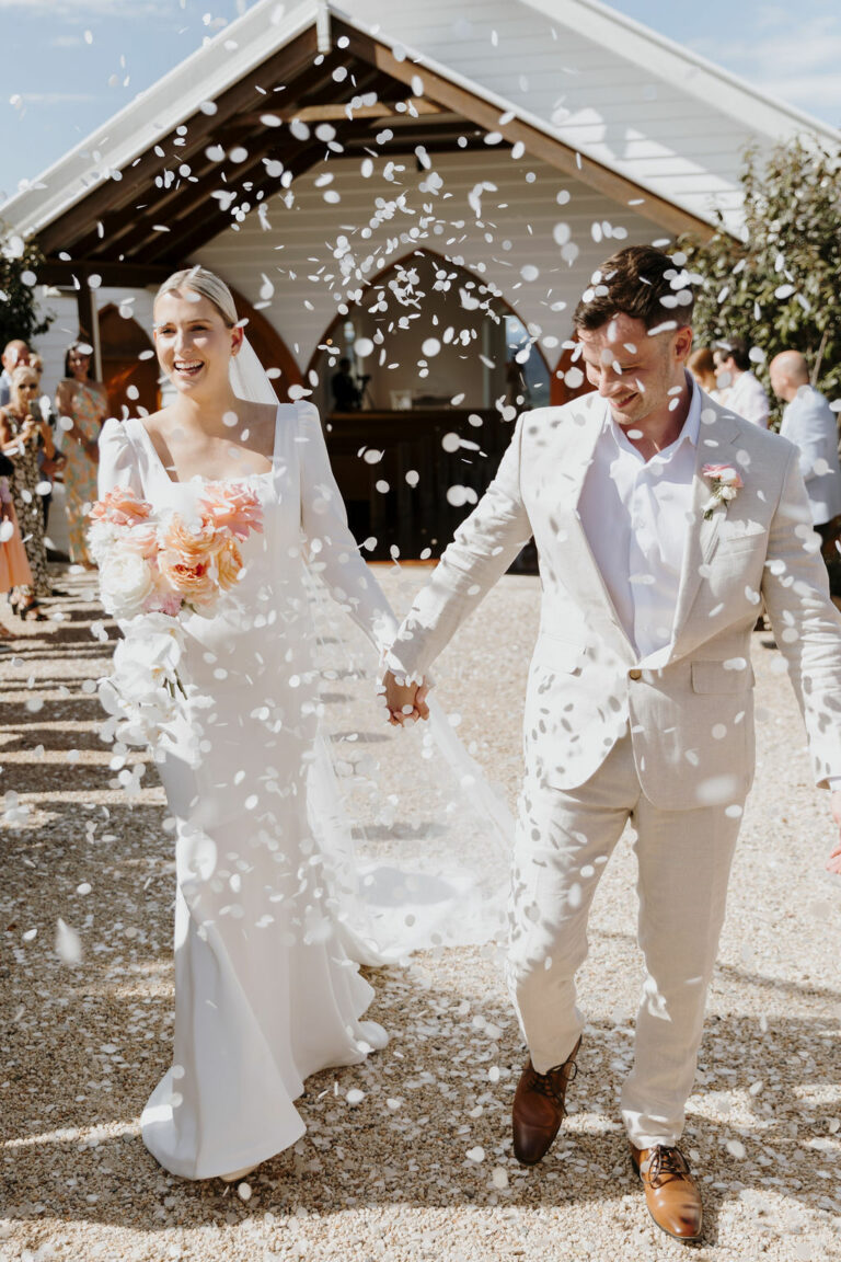 Bride and Groom walking through confetti