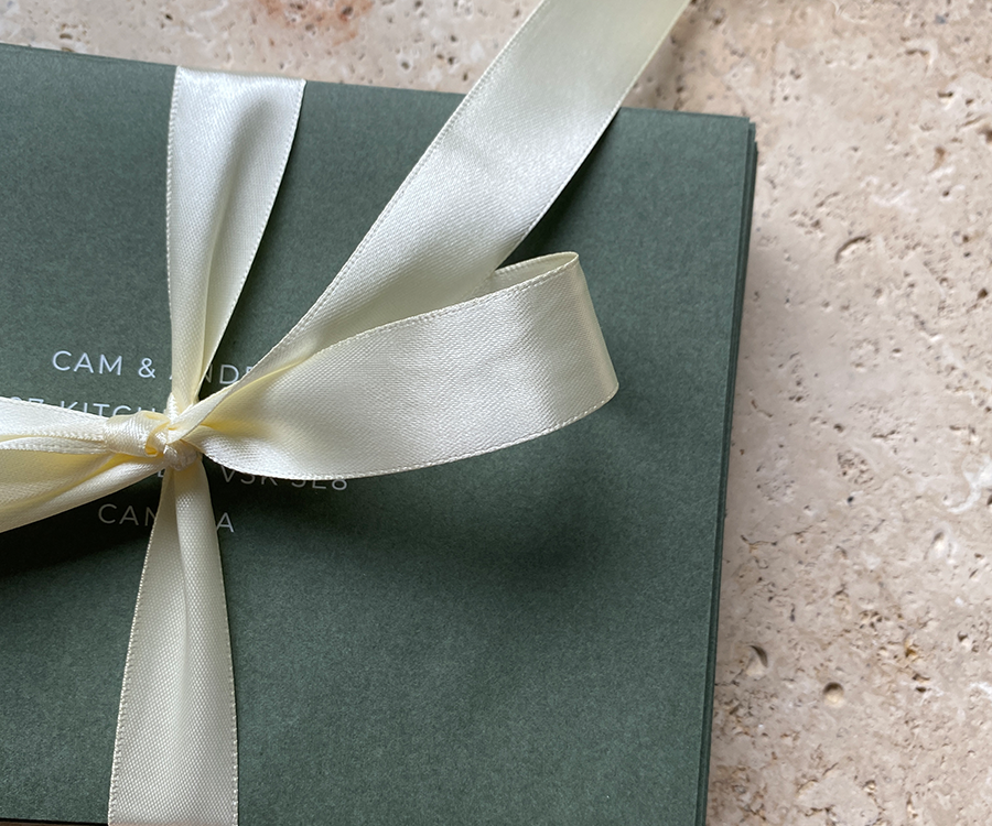 Green envelope with a ribbon wrapped around it