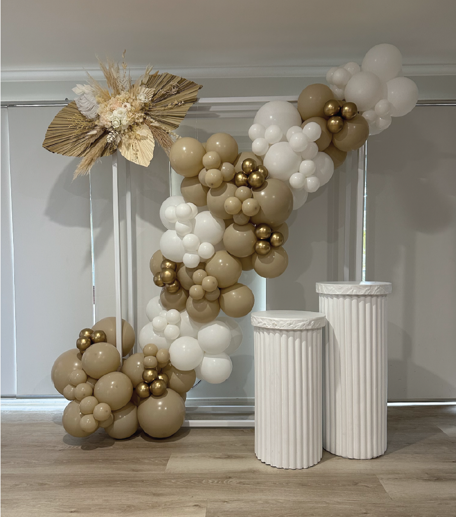 Gold and White Balloon Arrangement with Two White Plinths to the Right