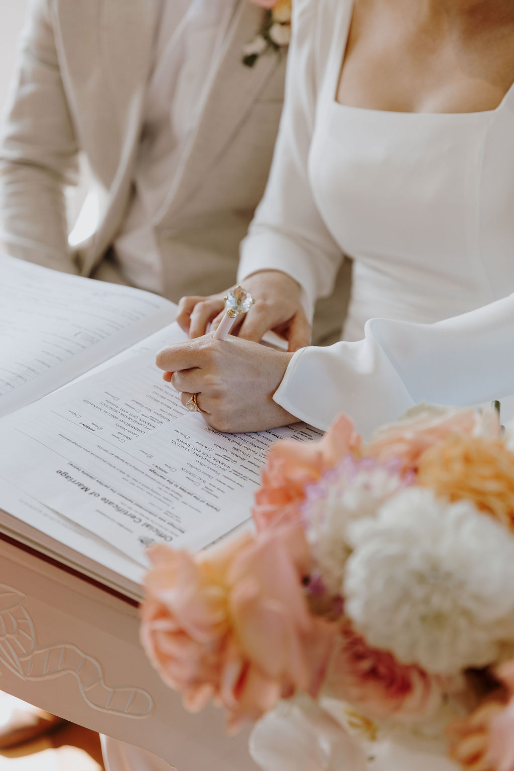 Husband and wife signing a marriage certificate