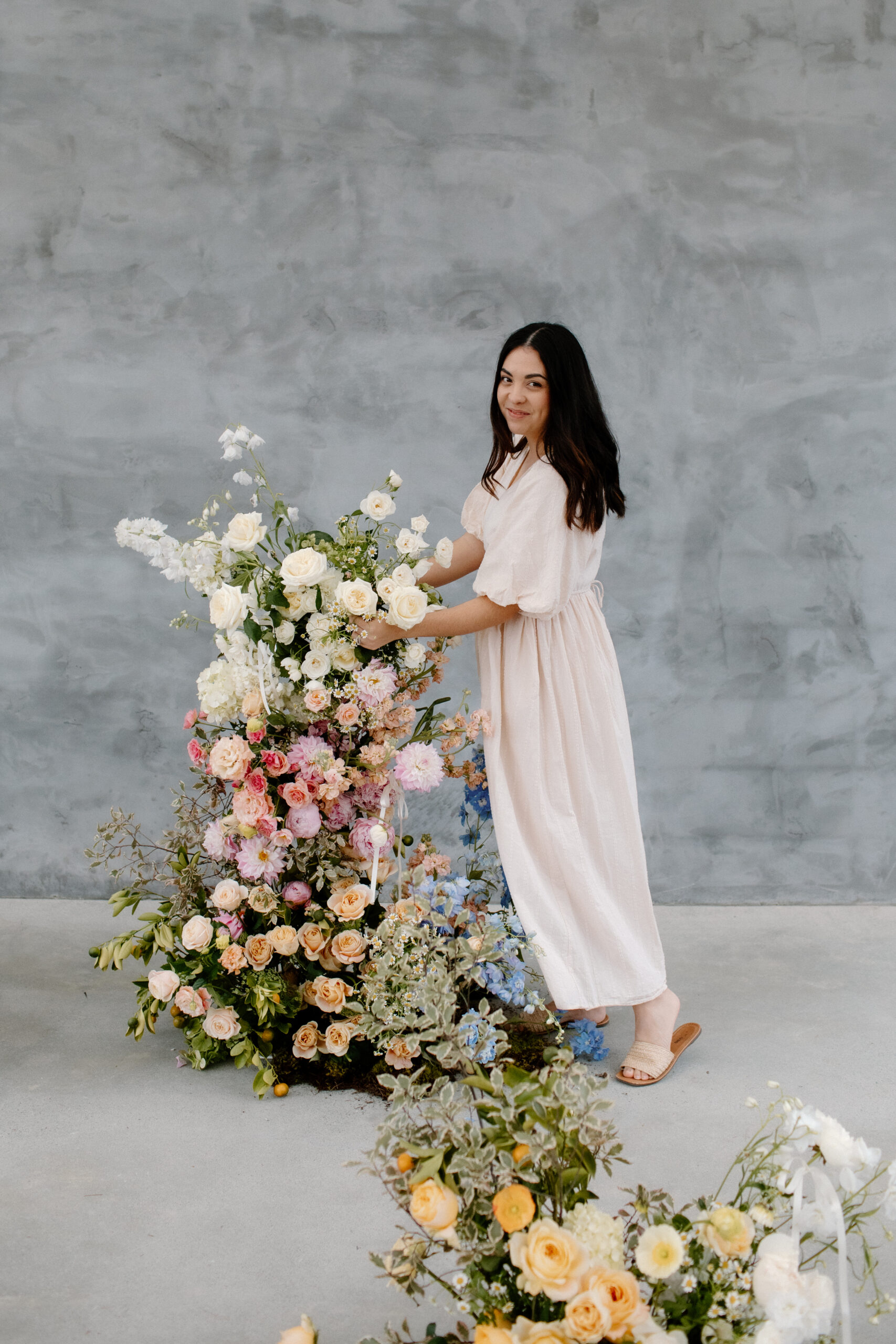 Sarah from Gwen Floral Co arranging a floral arbour