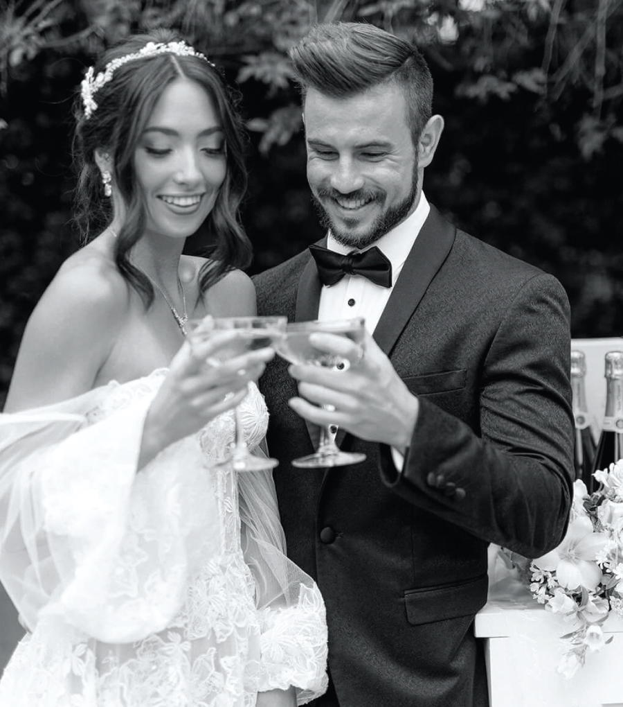 Bride and groom each holding a glass