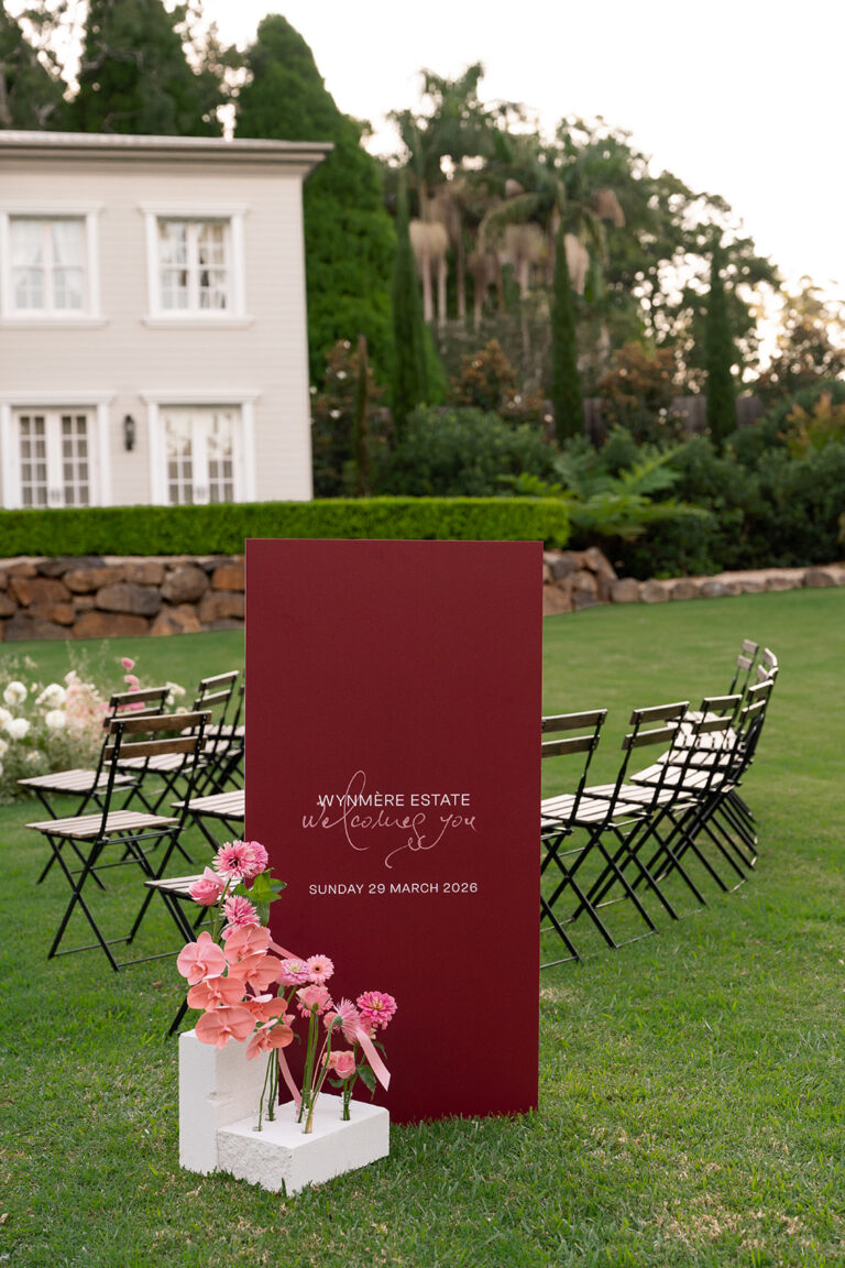 Burgundy welcome sign displayed at Wynmere Estate